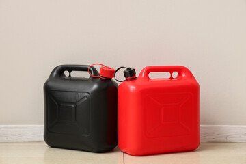 Different plastic canisters near white wall