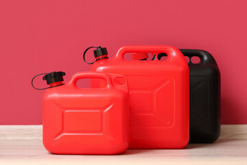 Different plastic canisters near red wall