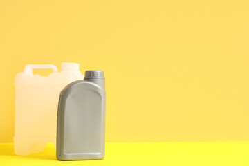 Different plastic canisters on yellow background