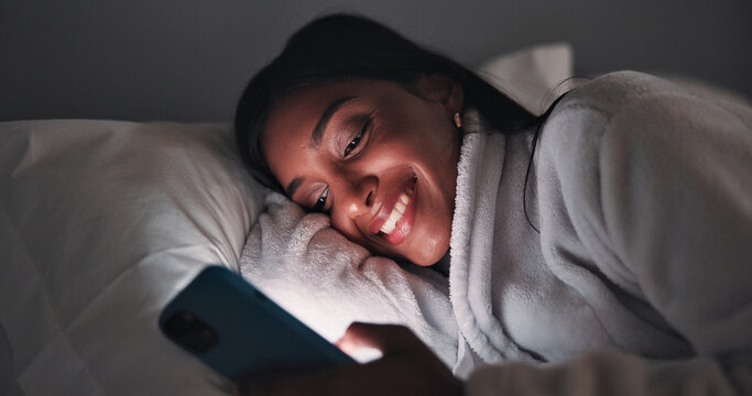 Smile, night or woman in bed with phone, online reading or video browse on social media. Happy, dark and female person in house with tech, ebook subscription or digital app scroll in late evening. - Powered by Adobe