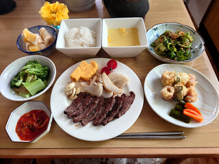 The typical menu found at a local diner: beef steak set meal (cut steak and grilled vegetables),...