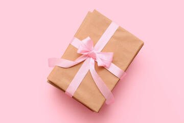 Books tied with ribbon on pink background