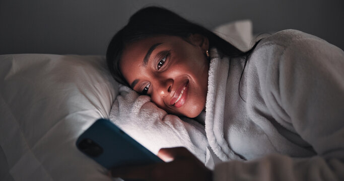 Streaming, night or woman in bedroom with phone, online reading or video browse on social media. Smile, dark or girl in house with tech, e book subscription or digital scroll in late evening.