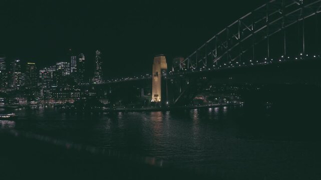 4K footage of Circular Quay and Sydney CBD with ferries and ships at night time from unique high ground perspective in High Quality Cinematic