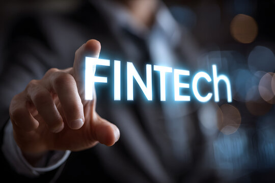Business, Technology, Internet and network concept. Young businessman shows the word on the virtual display of the future: Fintech