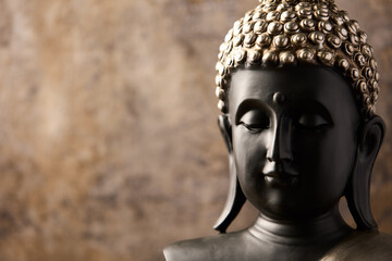 Meditating Buddha Statue on dark background. Soft focus. Close up. Copy space	
