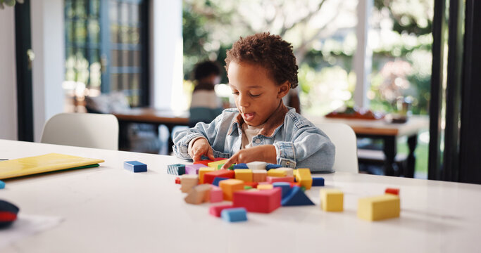 Learning, kid or game with building blocks in home for fine motor skills, problem solving or creativity. Education, african boy and wooden toys for sensory play, cognitive development or coordination