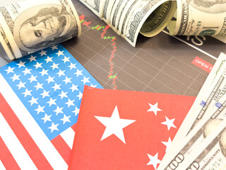 100 dollars and 100 yuan on a US and China flags background. US and China trade and tariffs war. Economic crisis, inflation, customs and commodity prices concept. Economic inflation, deflation or sta