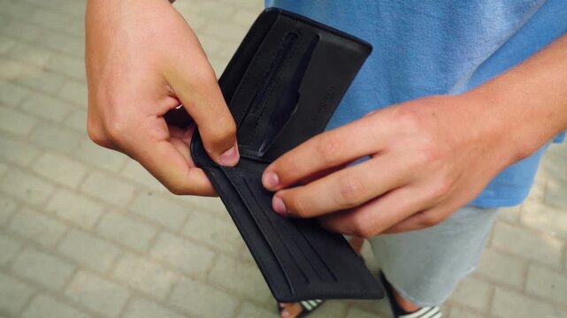 The poor man looks at the empty wallet 01