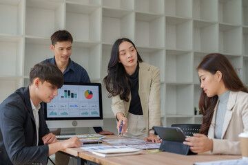 Business team analyzing data, discussing project strategy