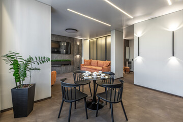 Modern Living Room with Orange Sofa and Black Dining Set
