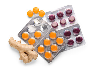 Cough drops in blisters with ginger on white background