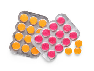 Blisters with cough drops on white background