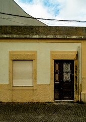 Exterior view of a building with a window and a door.