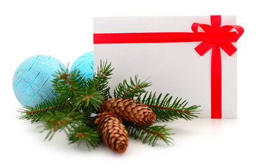 Christmas envelope with red ribbon, blue balls and spruce branch isolated on white background