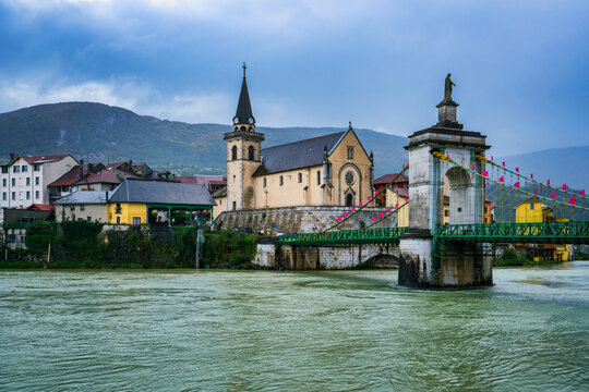 Seyssel village along Rhone river with suspension bridge