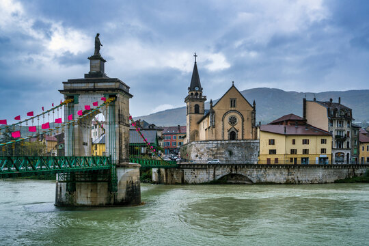 Seyssel village along Rhone river with suspension bridge