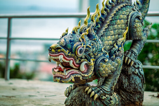 Background of Thailand's Chonburi religious attractions (Wat Khao Phra Khru viewpoint), with beautiful Buddha and Phaya Naga statues, tourists always come to make merit and take pictures at night.