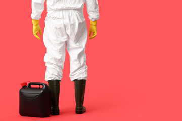 Mature man in protective uniform with canister on red background