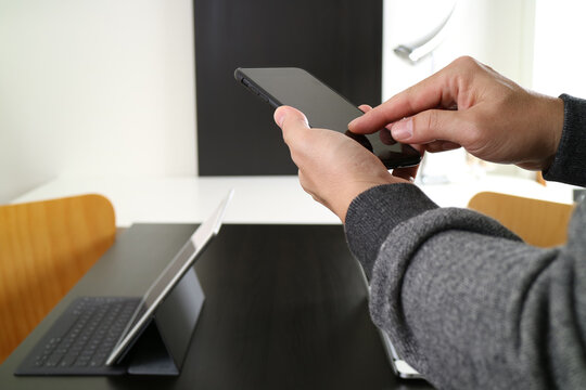 Using smartphone for communication in modern workspace - Powered by Adobe