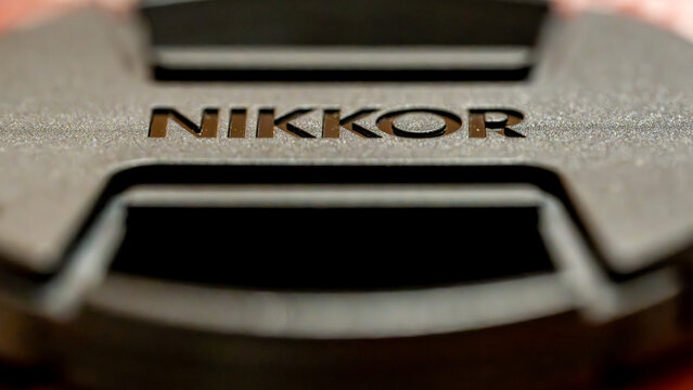 Sainte-Marie-la-Blanche, France, October 26, 2025: close-up macro view of a Nikkor lens cap, detail of Nikon camera equipment, concept of photography, optics and precision tools.