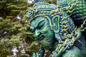 Fototapeta premium Background of Thailand's Chonburi religious attractions (Wat Khao Phra Khru viewpoint), with beautiful Buddha and Phaya Naga statues, tourists always come to make merit and take pictures at night.