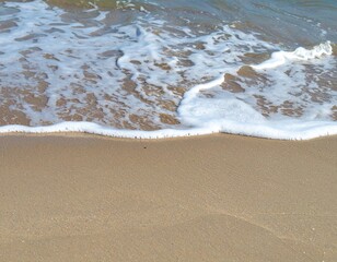 Ocean tide washing sandy shore showing movement of natural marine environment