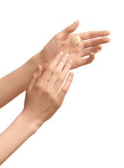 Female hands applying cosmetic cream on white background