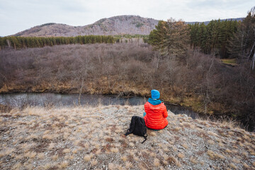 Tranquil observer relaxing, Peaceful individual observing flowing stream, Serene person seated...