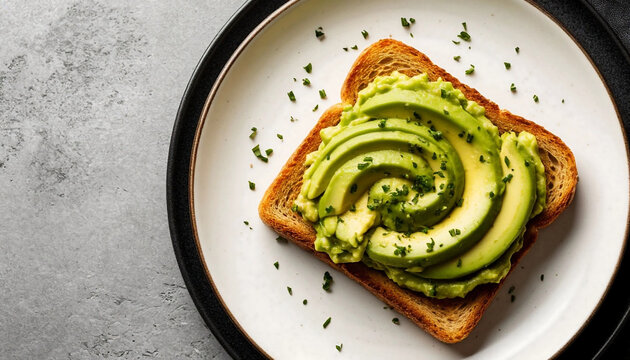 Avocado toast showcases creamy green slices atop golden whole-grain bread, garnished with fresh herbs and black pepper for a vibrant, fresh appeal. Rustic flat lay on a white plate against neutral 