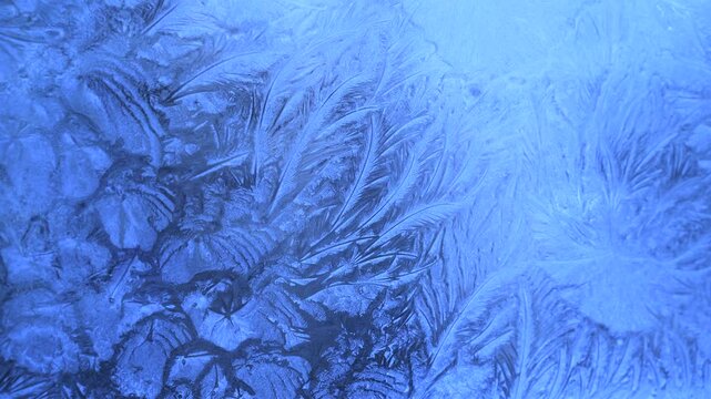 Abstract frosty pattern on glass, background texture on the window