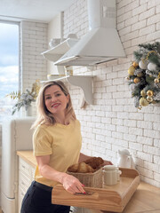 Elegant woman decorating room for Christmas dinner