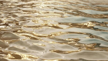 Golden reflections on a rippling water surface. Concept Golden hour reflections, Rippling water texture, Shimmering light on water, Liquid gold tones, Calm reflective mood