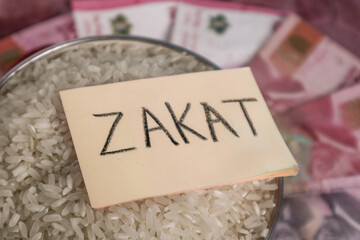 A concept of Zakat al-Fitr and Eid al-Fitr alms, featuring a pot of rice, a sticky note with "Zakat" written on it, and rupiah banknotes.