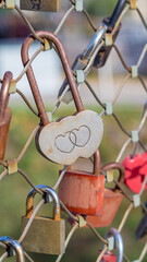 Heart-shaped padlock among love locks on Makartsteg bridge as symbol of romantic european trip, Salzburg, Austria