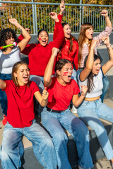 Female sport fans celebrating team victory at stadium