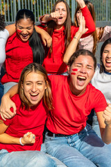 Group of cheerful women supporting sports team