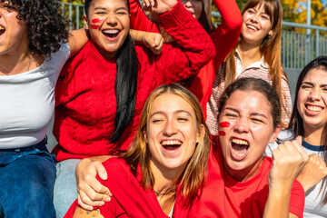 Young women friends celebrating sport event cheering