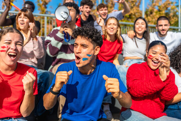 Multiracial young people celebrating and cheering during sport event