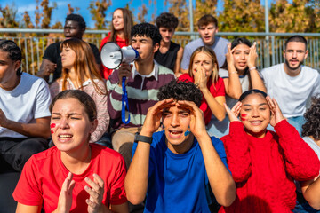 Diverse young sports fans cheering and showing emotions
