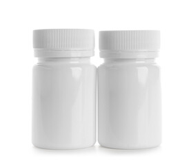 Blank plastic vitamin bottles on white background