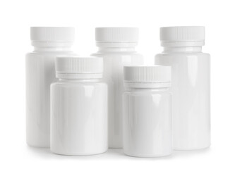 Many blank plastic vitamin bottles on white background