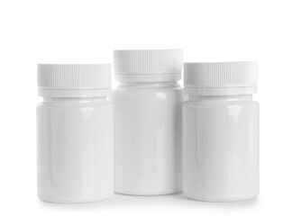 Blank plastic vitamin bottles on white background