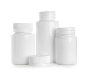 Blank plastic vitamin bottles on white background