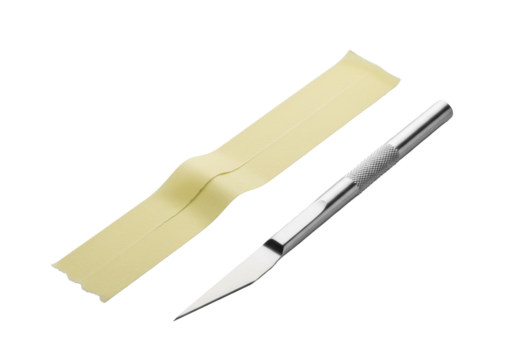 A light yellow masking tape strip with torn edges, angled 45 degrees, beside a sleek silver craft knife, on a seamless transparent background, close-up studio concept of minimalist precision