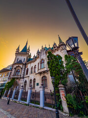 Korice gothic mansion with ivy and towers. Gothic mansion in Korice covered with ivy and historic detailing against evening sky.