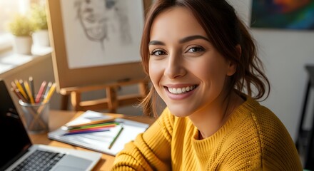 Portrait of a beautiful smiling female artist working in her sunlit studio.