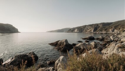 Serene coastal scene features a calm sea framed by rocky shores and cliffs under a bright sky