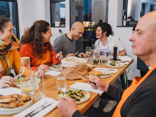 Friends enjoy team building cooking class dinner in cozy kitchen