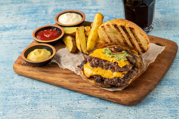 Smash burger with cheddar cheese and caramelized onions, served with fries